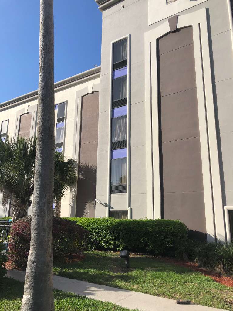 Commercial property exterior upgrade with finished stone-style cladding.