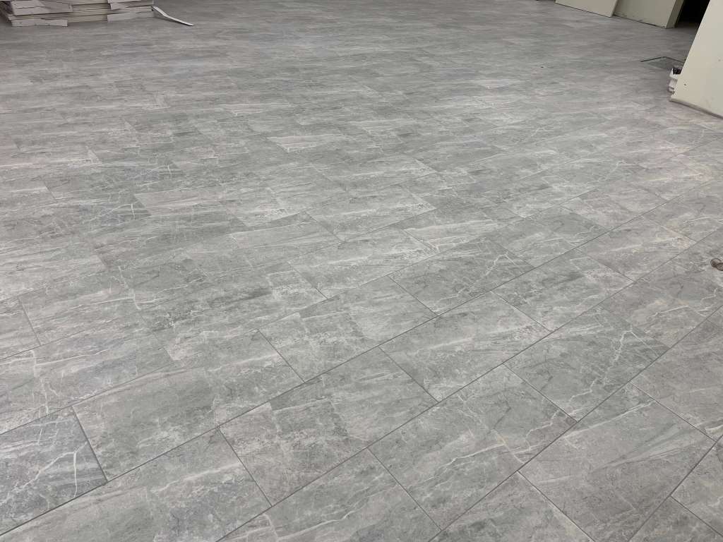 Commercial gray tile flooring installed across a large interior footprint.
