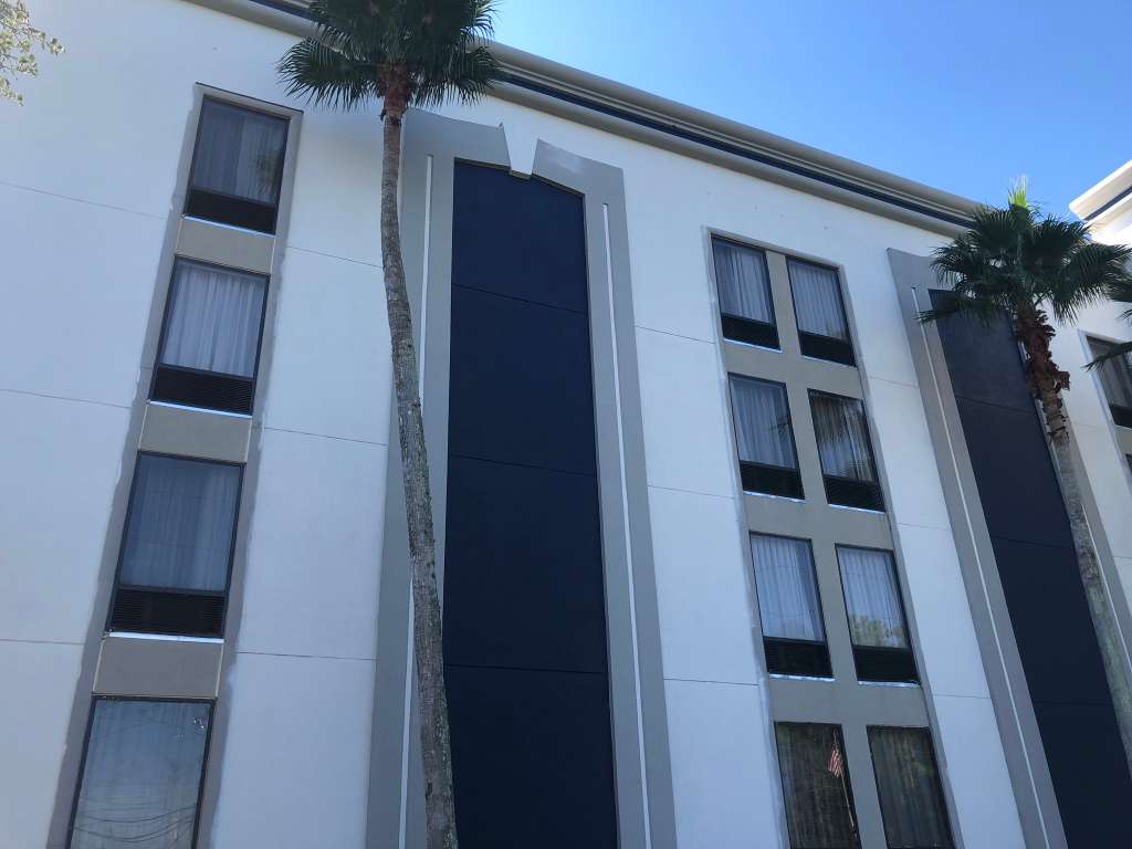 Commercial property exterior with updated facade treatment and vertical accent panels.