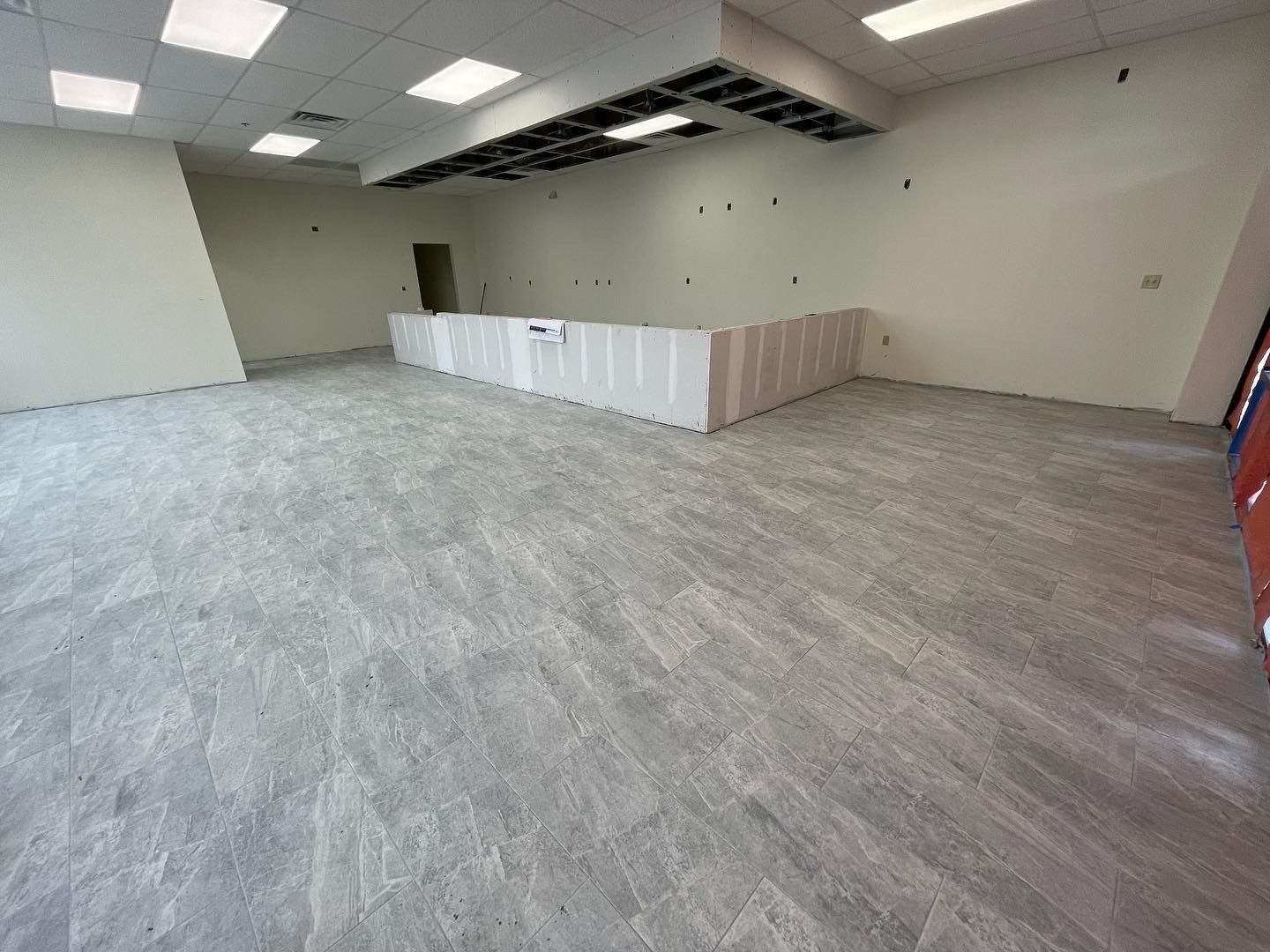Commercial interior buildout in progress with new partitions and drywall work.