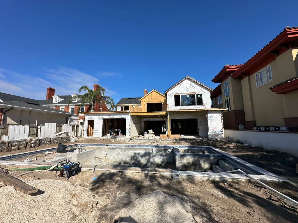 Multi-level residential framing underway during structural improvement work.