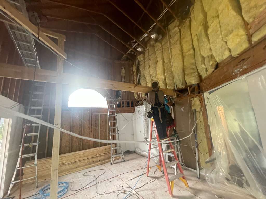 Interior framing and electrical rough-in work underway during a residential renovation.